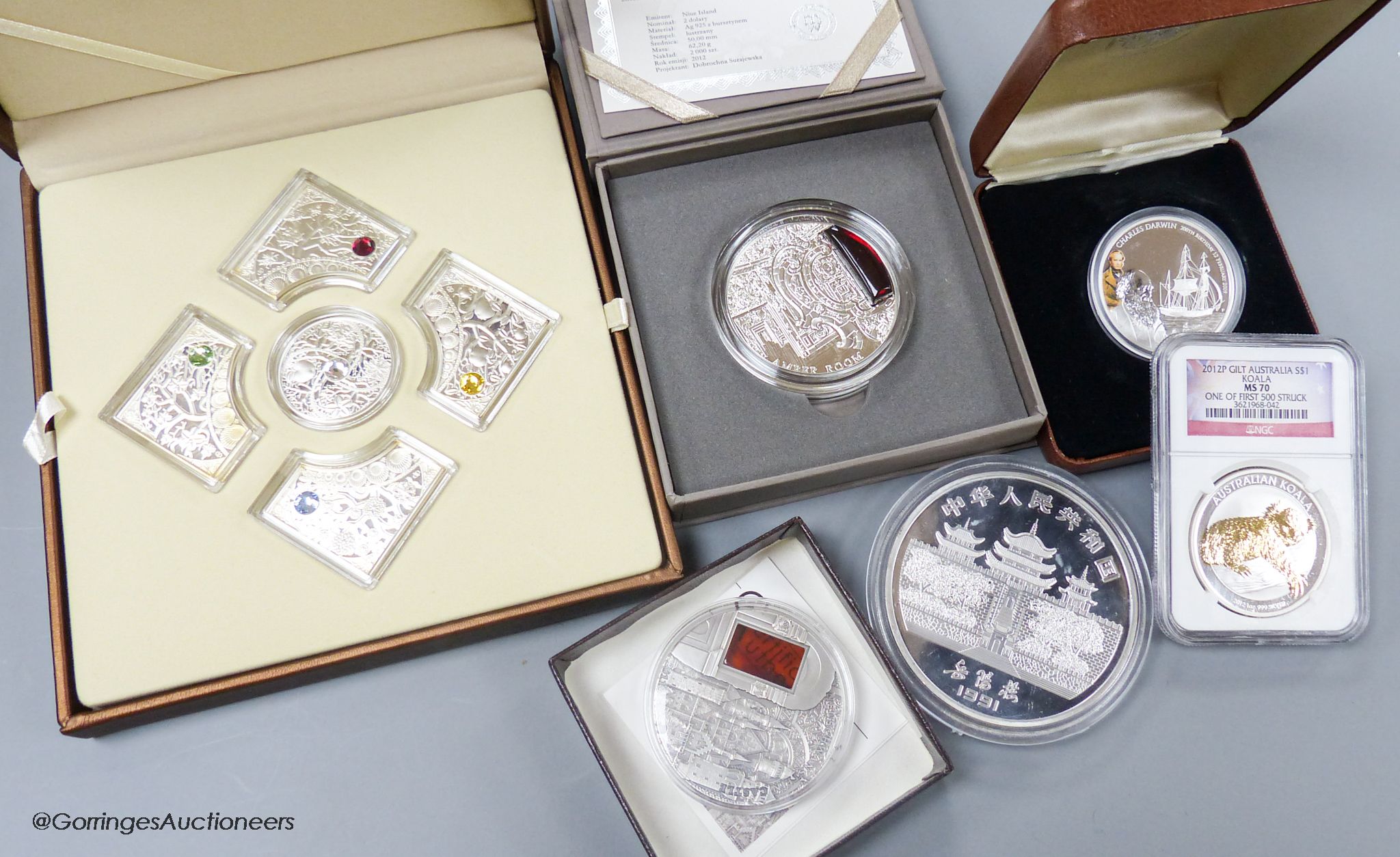 A box of assorted collectors coins and medallions.